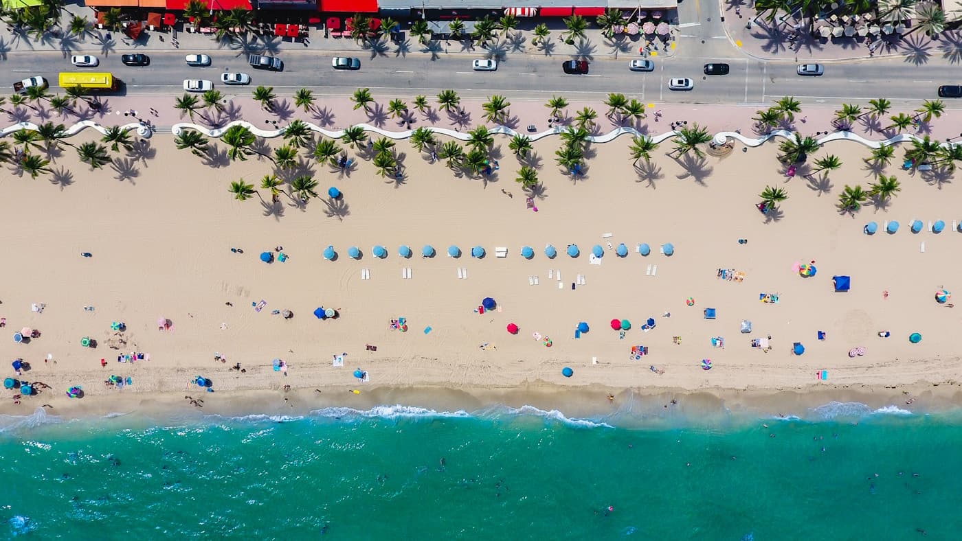 An aerial view of a South Florida beach lined with umbrellas.
