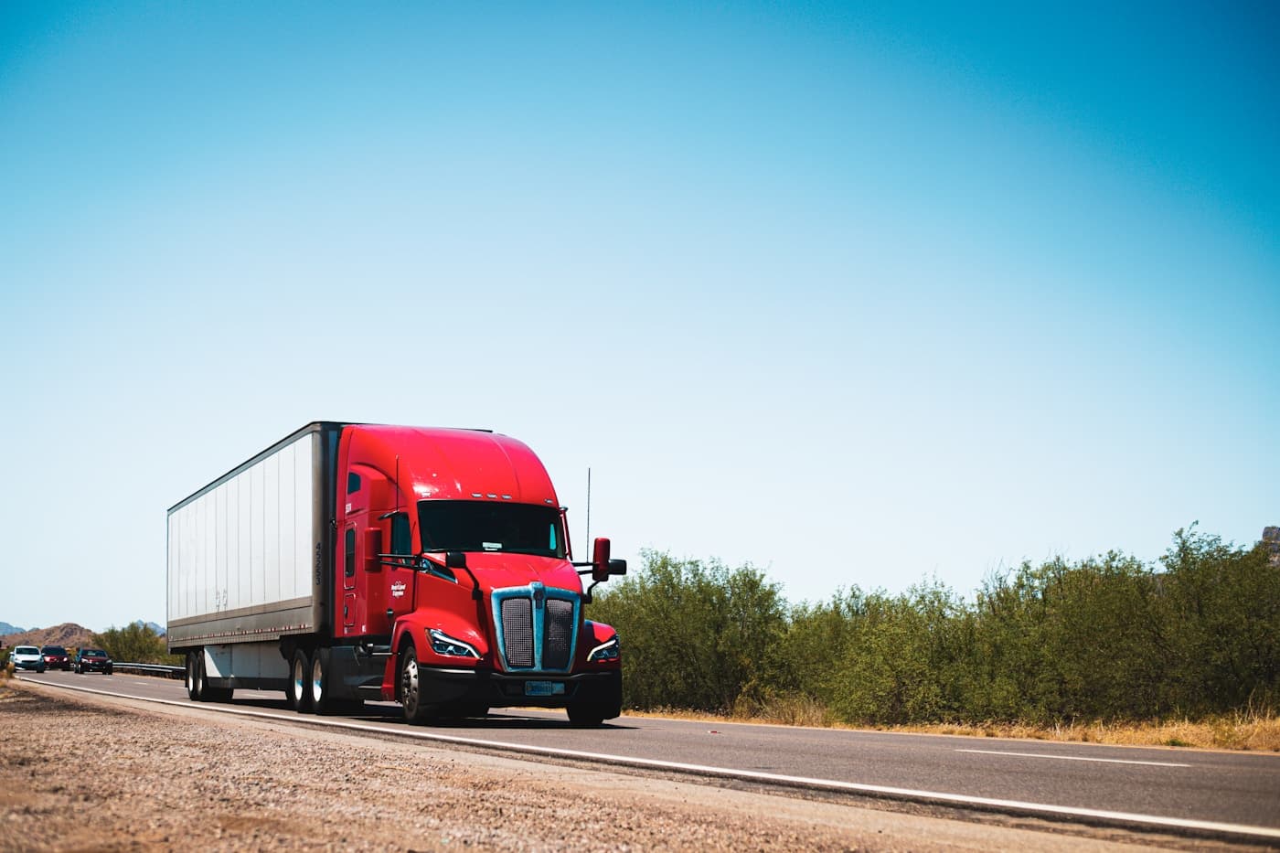A red tractor unit and trailer on an open road.