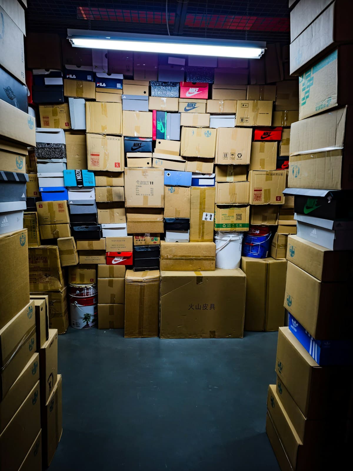 A room filled with cardboard cartons stacked from floor to ceiling.